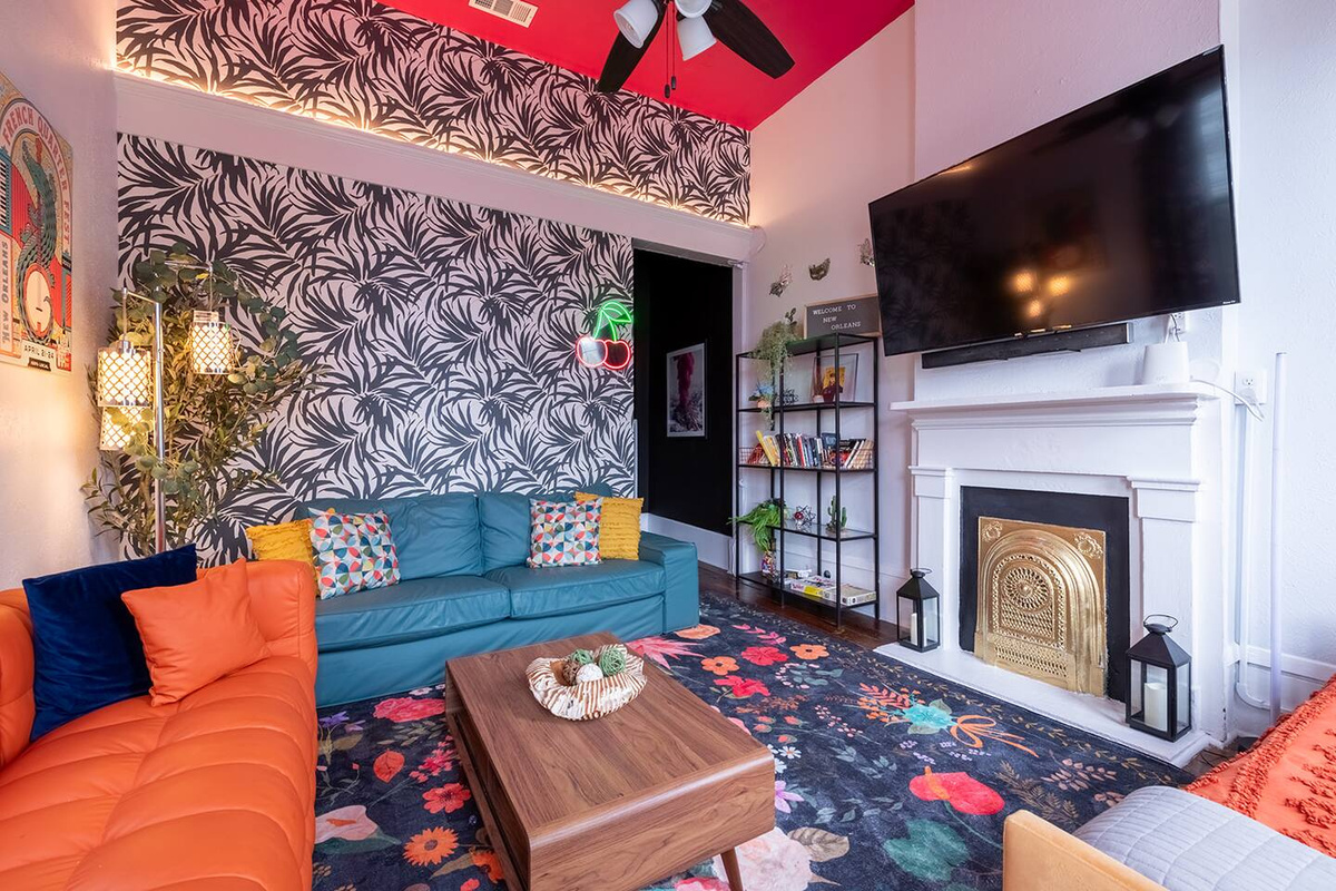 Green & orange couches, cherry lights, tropical wallpaper, books, crazy curtains, alligator, gold fireplace, 65-inch Roku TV, pink ceiling! 