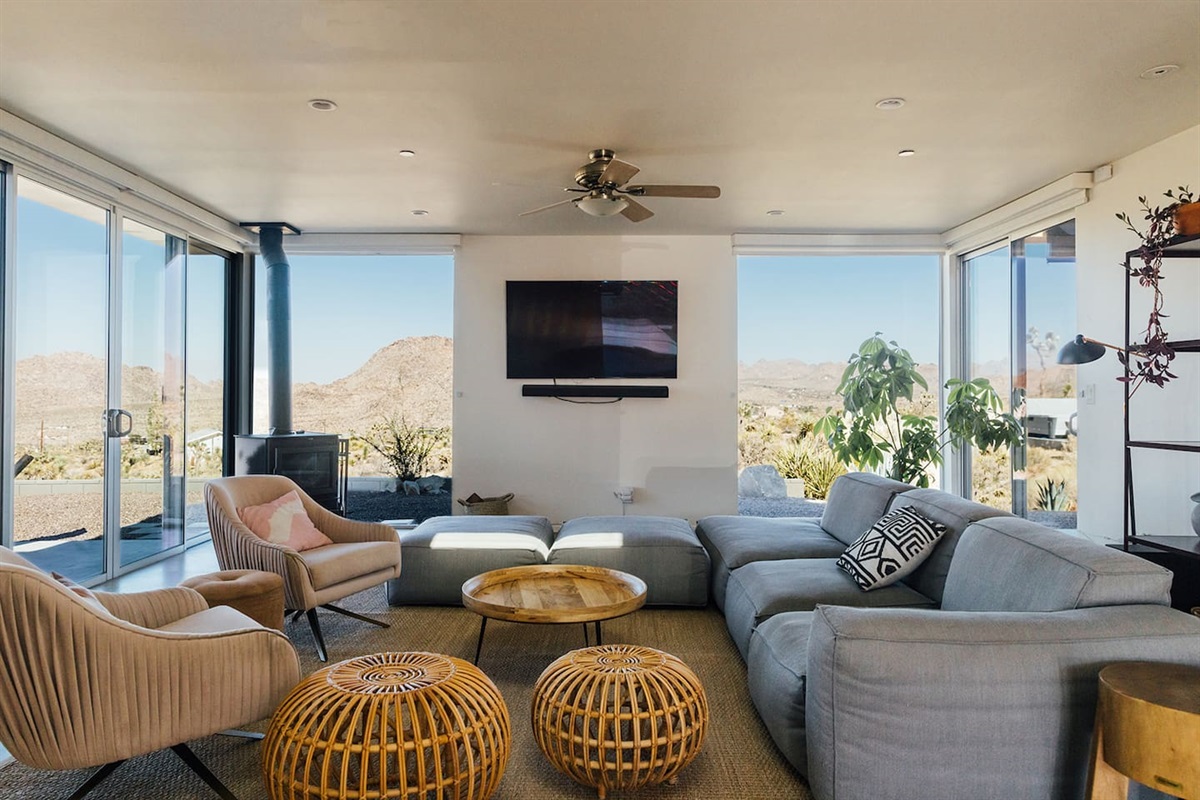 Spacious living room with mountain view complete with tv, wood stove, record player, records, board games and books.