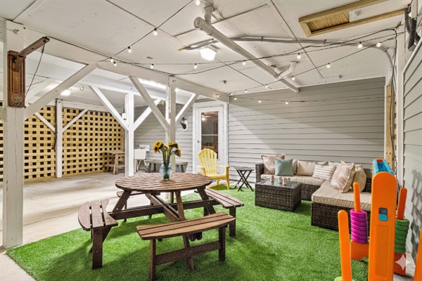 Lounge area under the house is perfect for relaxing evenings or rainy days at the beach.