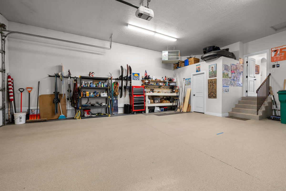 Large garage with plenty of space for vehicles, kayaks, bikes, skis, and other recreational gear.