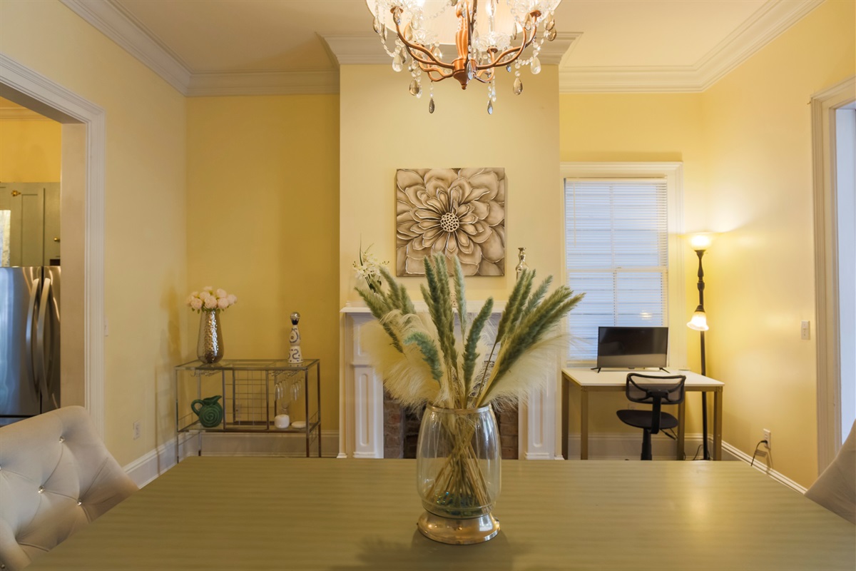 A grand light fixture anchors the dining room, adding elegance to every meal.