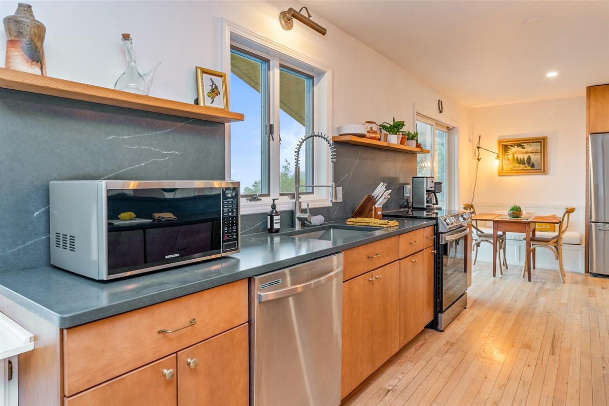 Prep and cook with ease in this well-equipped kitchen featuring stainless steel appliances and tons of counter space.