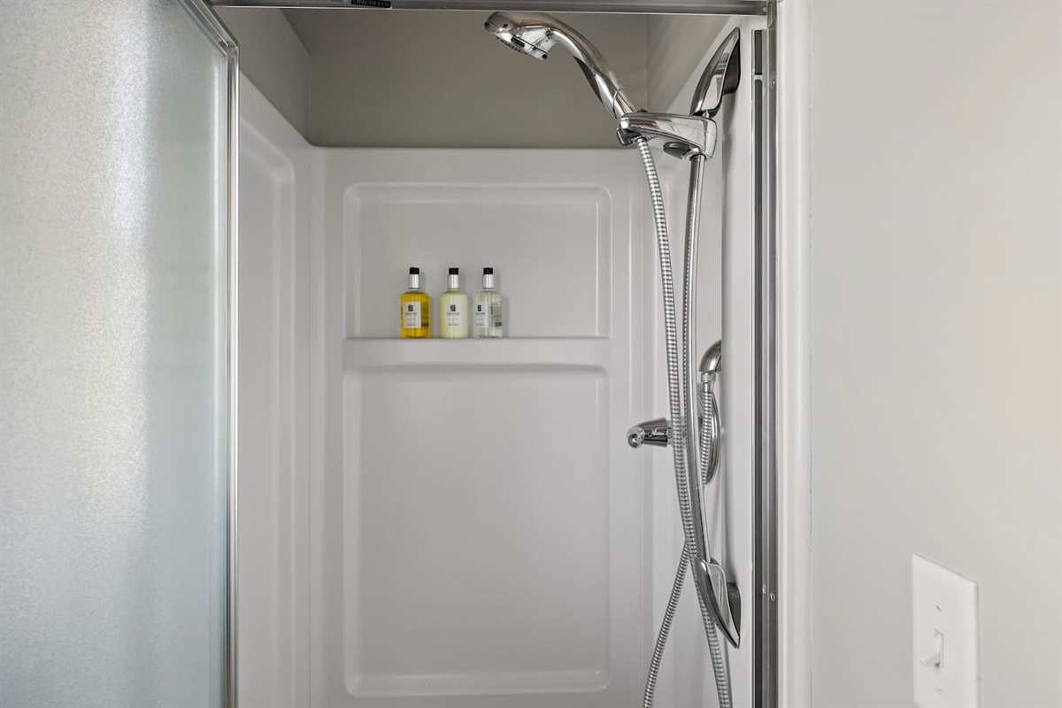 Main floor shower is located in laundry room and is perfect for cleaning off after a day at the beach.