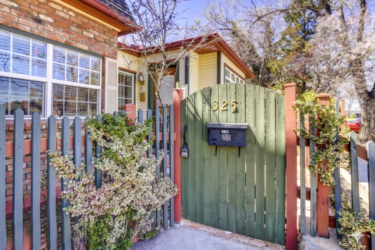 Step through this enchanting green gate and discover a hidden oasis.