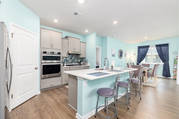 Welcome to our gourmet kitchen, boasting a stylish, upgraded countertop comfortably seating three. Crafted for culinary enthusiasts, it marries modern design with functionality, ideal for meal