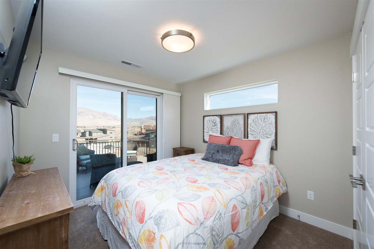 Upstairs bedroom with private balcony access and fresh mountain air