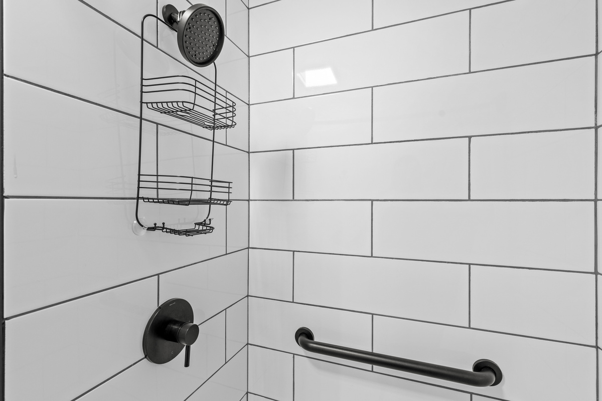 The beautifully updated walk-in shower features modern finishes and plenty of space to refresh after a day outdoors.