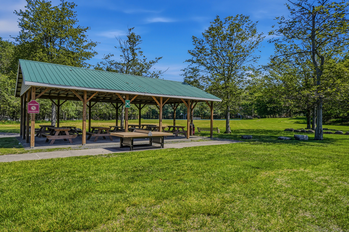 Community picnic pavilion surrounded by open green space