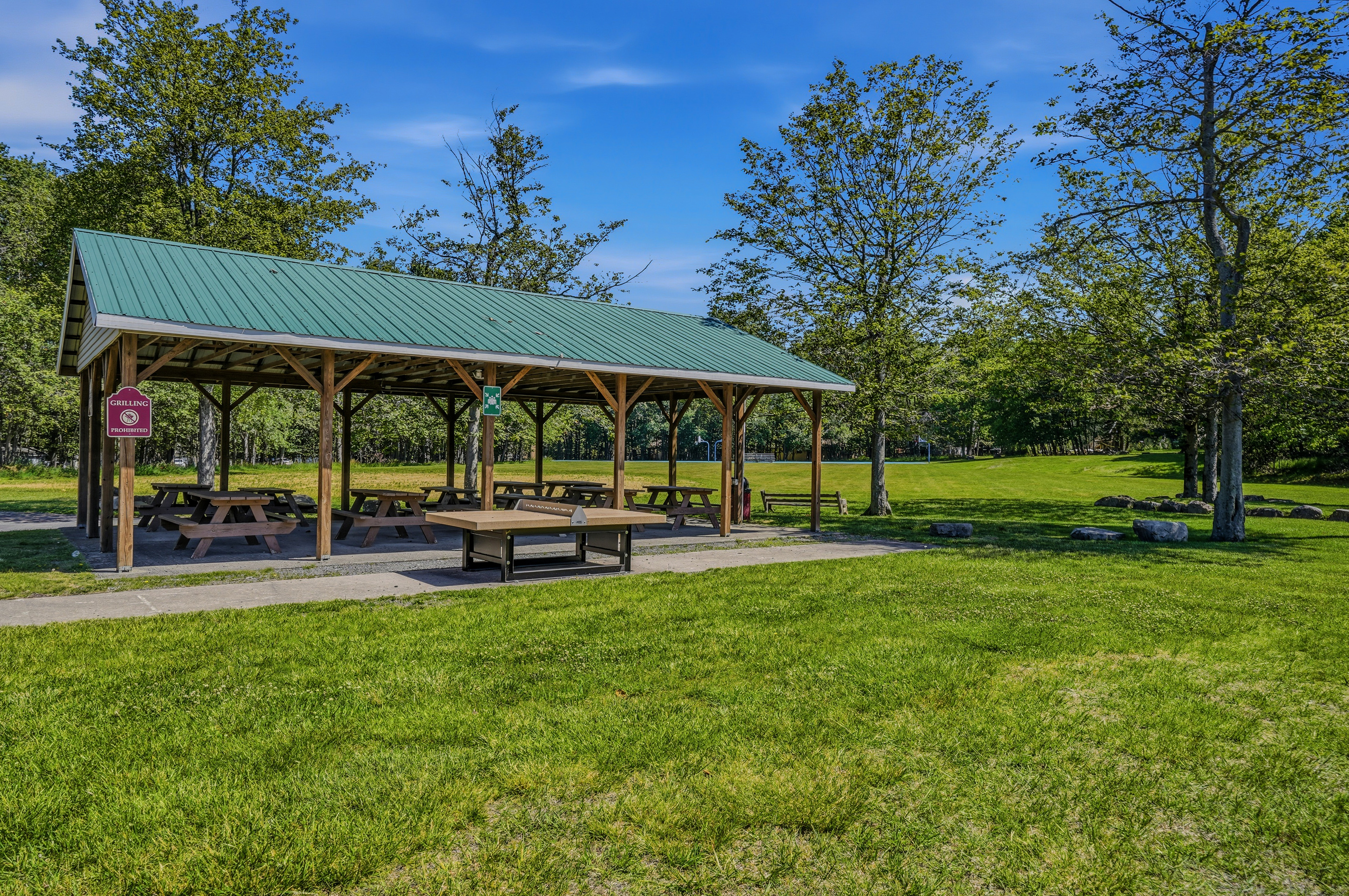 Community picnic pavilion surrounded by open green space