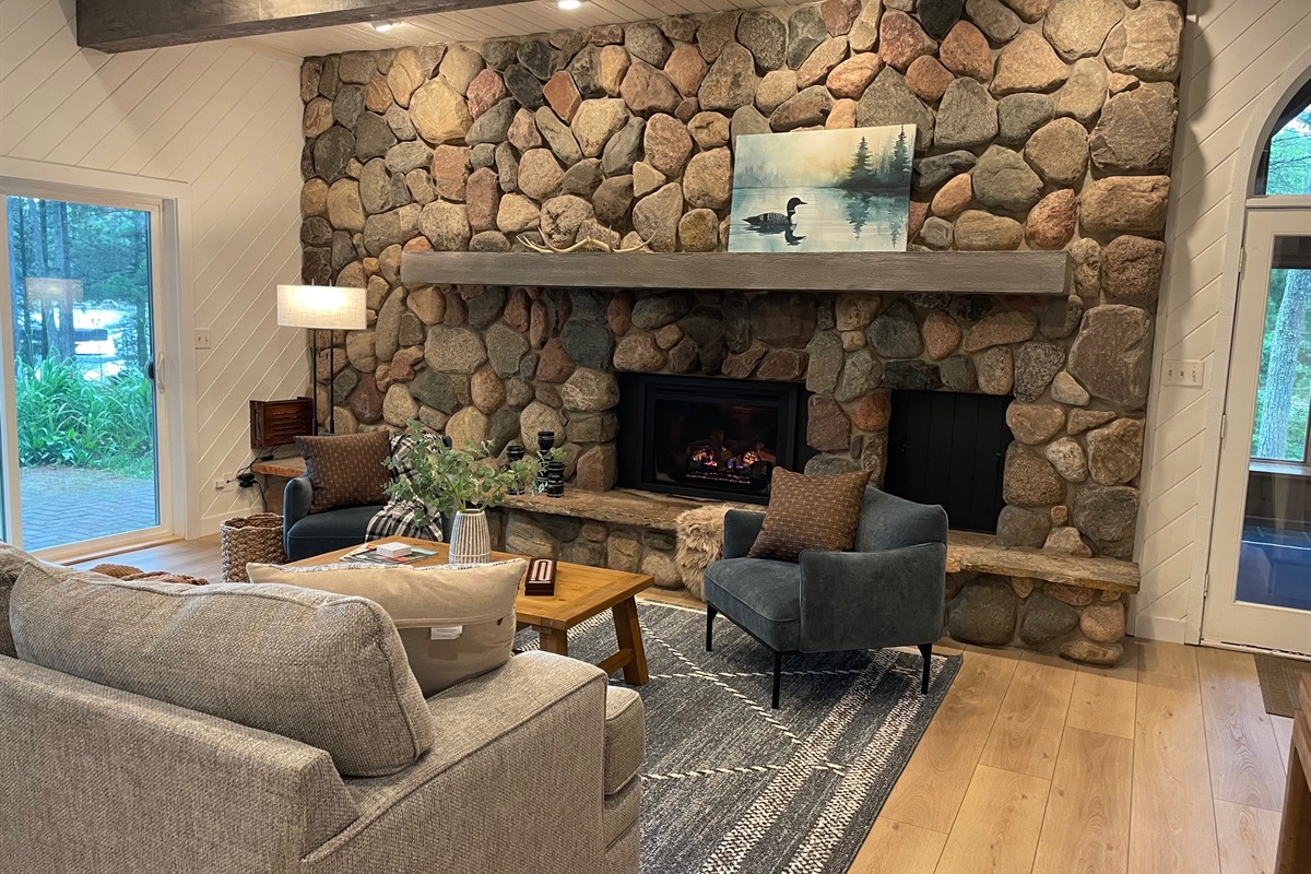 A beautiful fieldstone gas fireplace anchors the living room