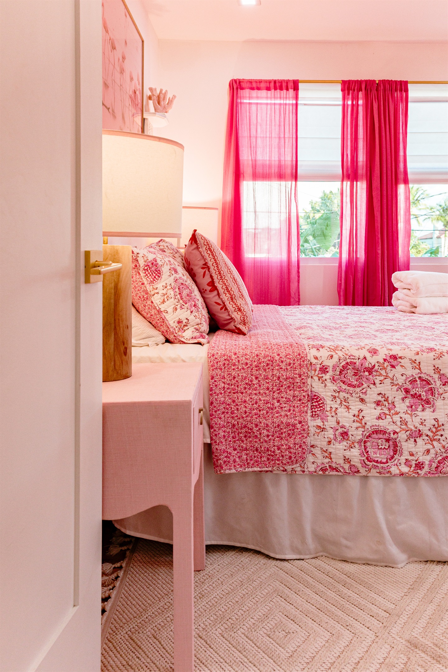 The second cottage bedroom is draped in themes of red and pink, a colorful and comfortable place to relax for a long evening's rest.