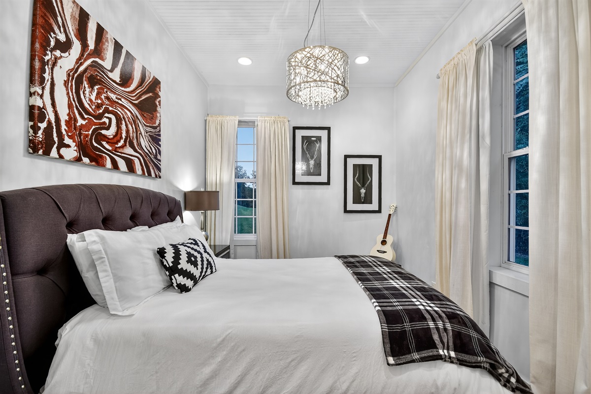 This cozy queen bedroom features stylish touches, plush bedding, and peaceful vibes&mdash;perfect for a restful night after exploring everything Blue Ridge has to offer. 