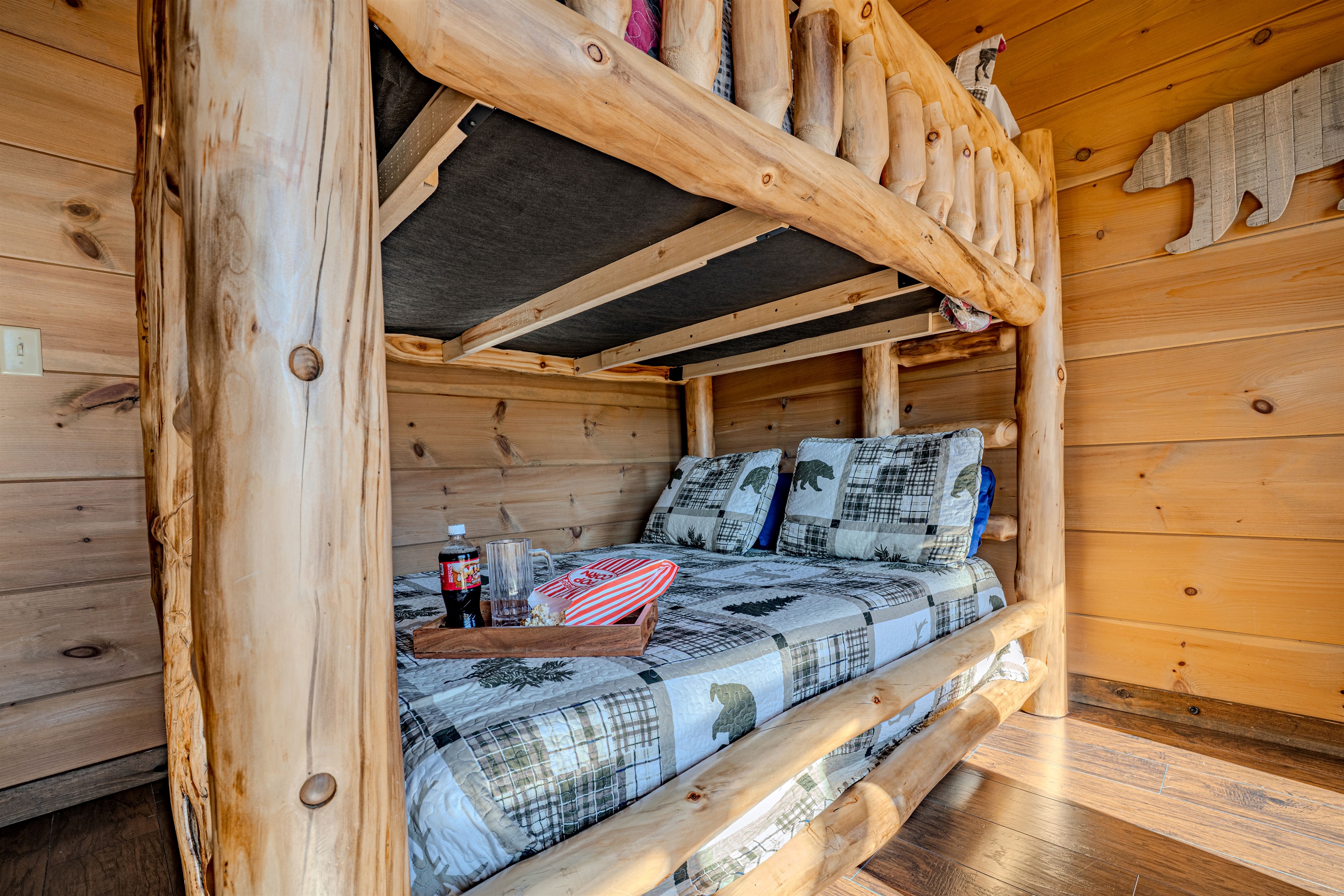 Cozy lower bunk with reading lights and comfy bedding.