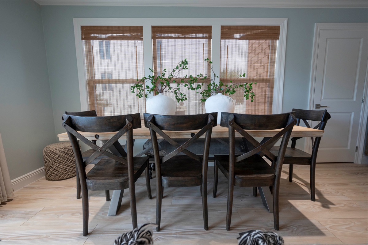 Enjoy rustic charm with wooden chairs, cozy decor, and natural light in this inviting dining space.
