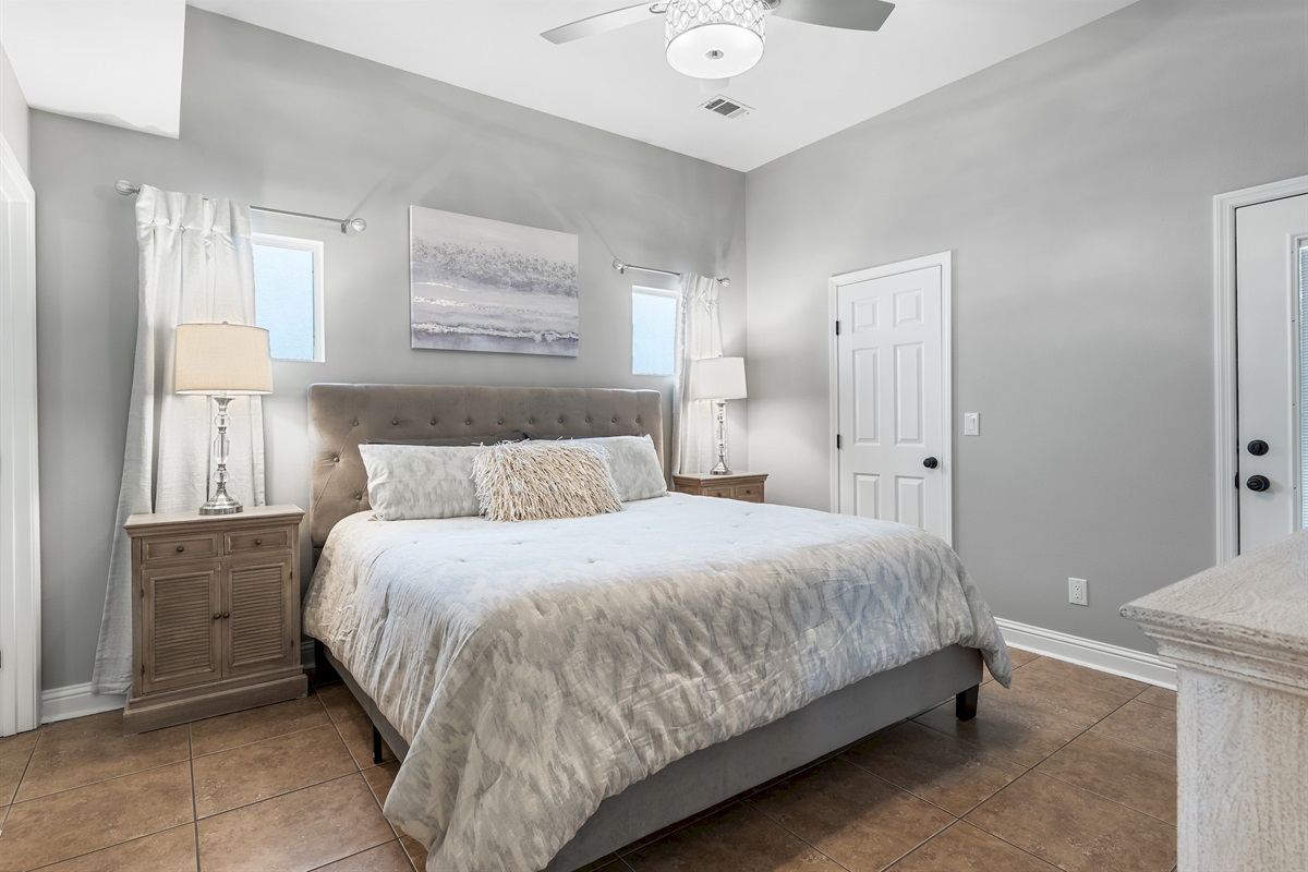 Master king bedroom with soft coastal tones and natural light