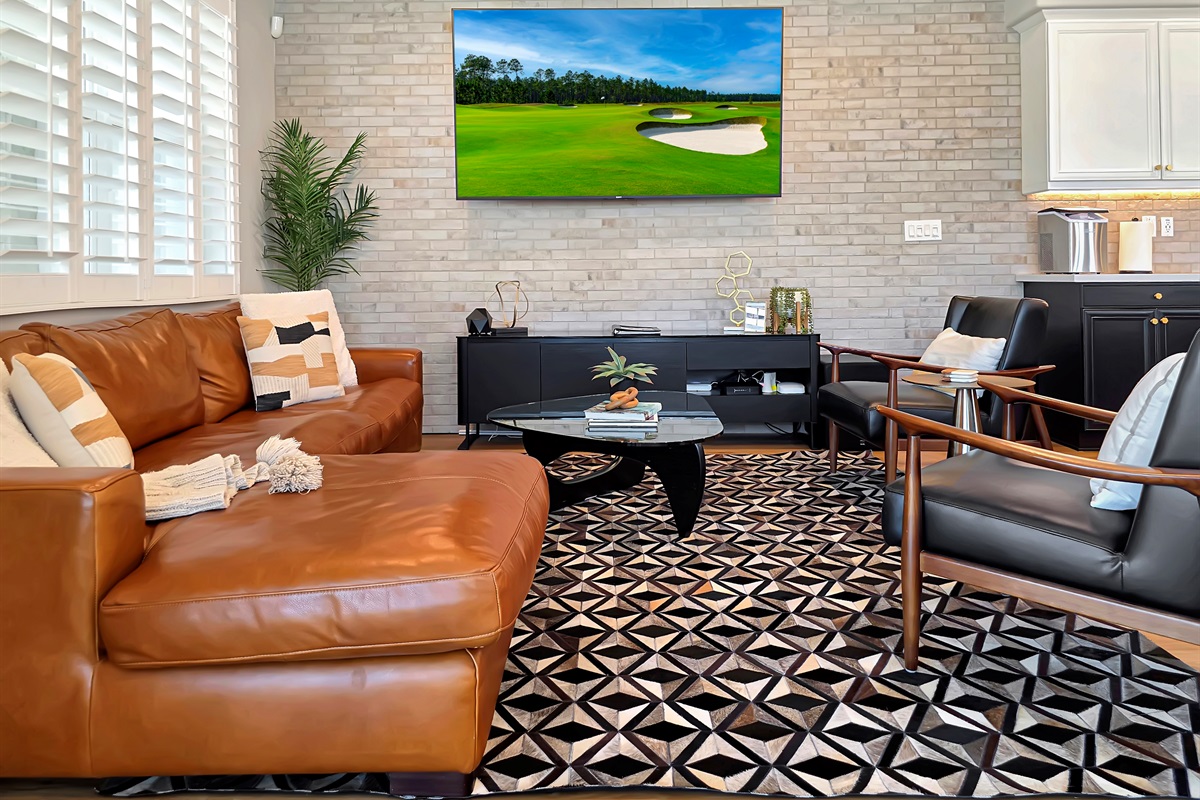 Plush Italian leather sofa & armchairs in the living room with an 87" HDTV.