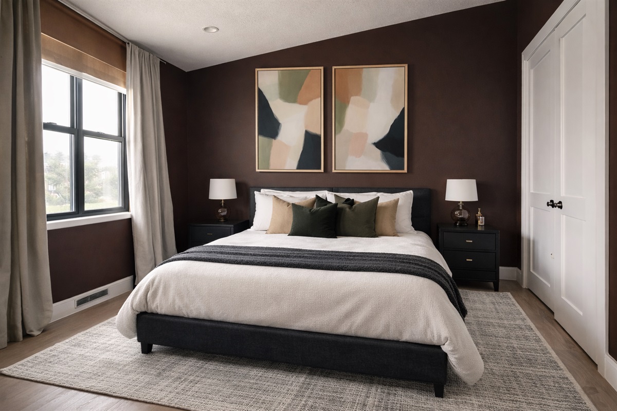 This cozy bedroom #3 features a comfortable queen bed with crisp white linens and layered pillows for a hotel-quality sleep. Blackout curtains help ensure a restful night, making it a comfortable retreat for couples or additional guests