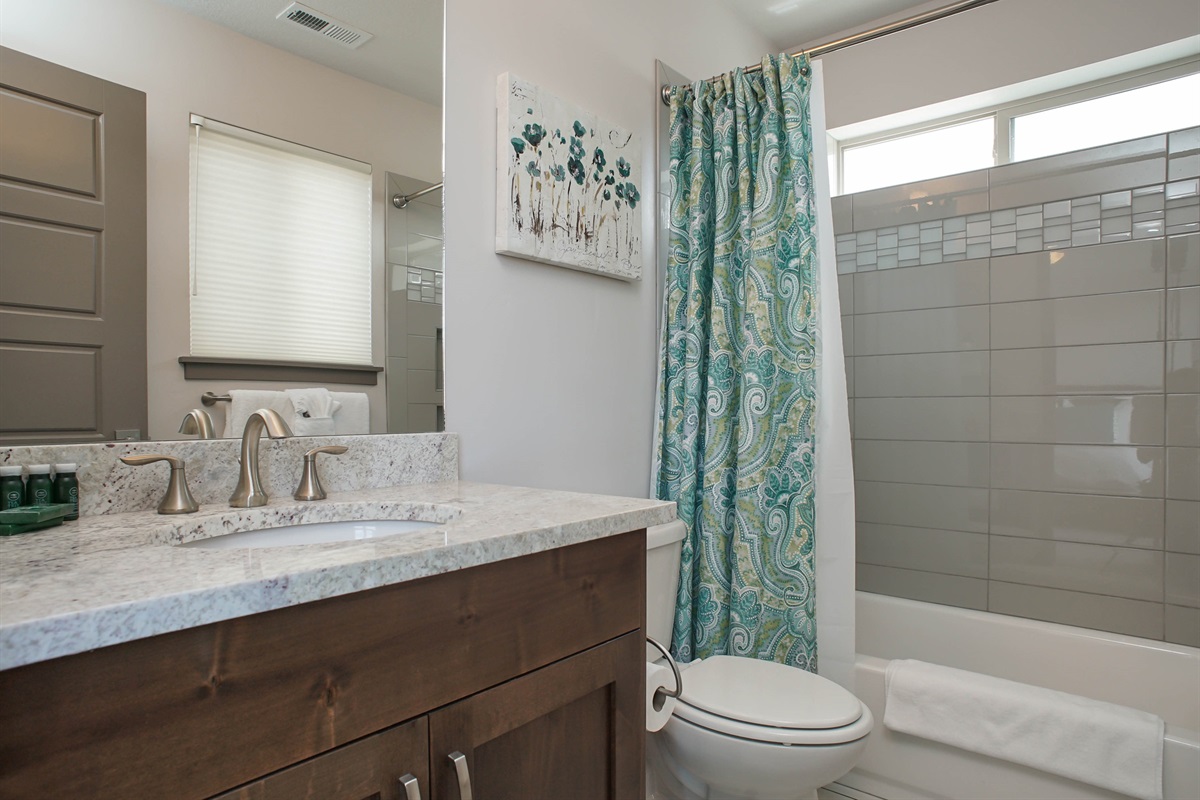 A stylish ensuite bathroom with clean finishes and a tub/shower combination, designed for comfort and convenience.
