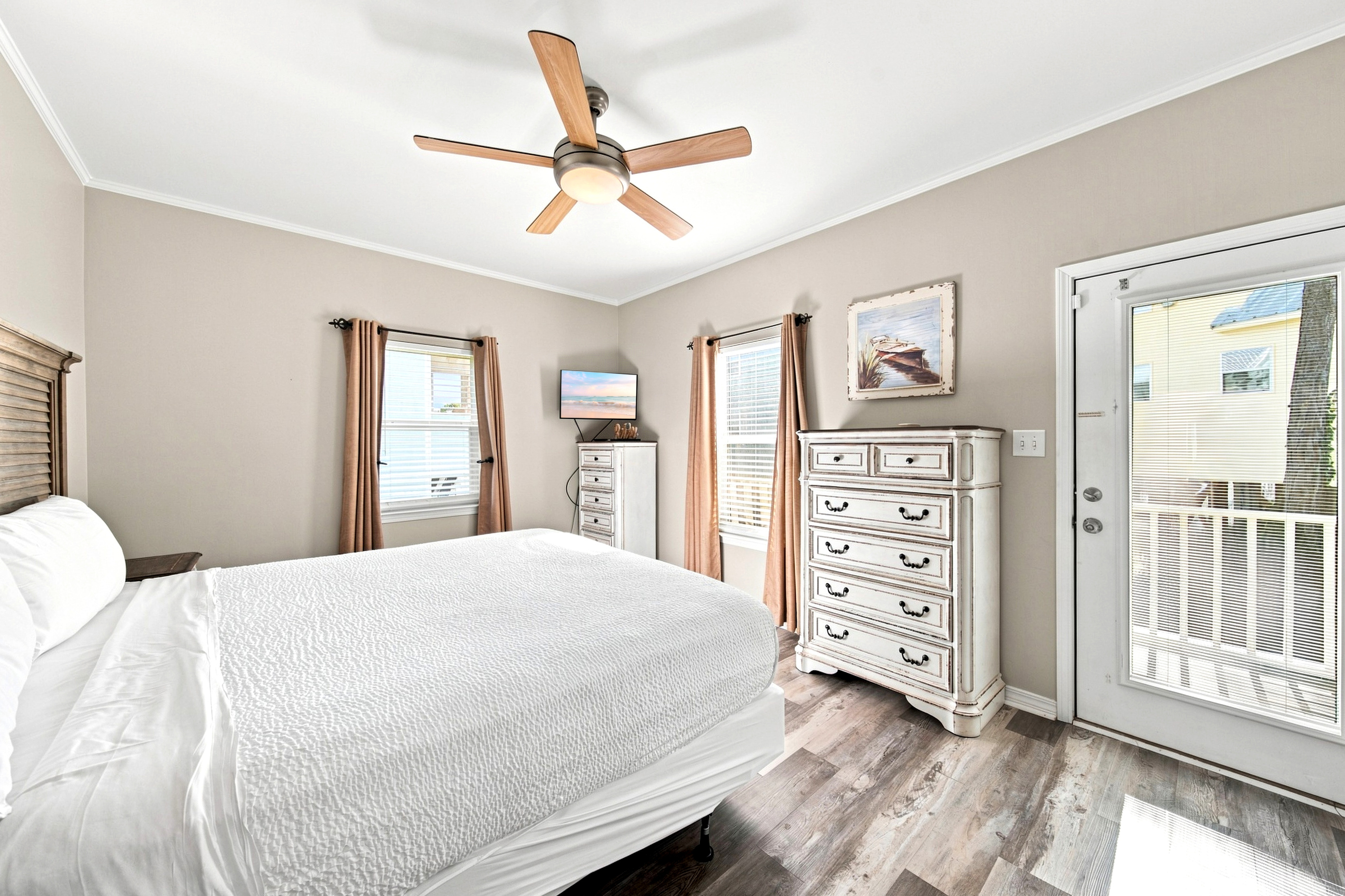 A comfortable queen guest bedroom with plenty of natural light — ideal for couples or family members traveling together.