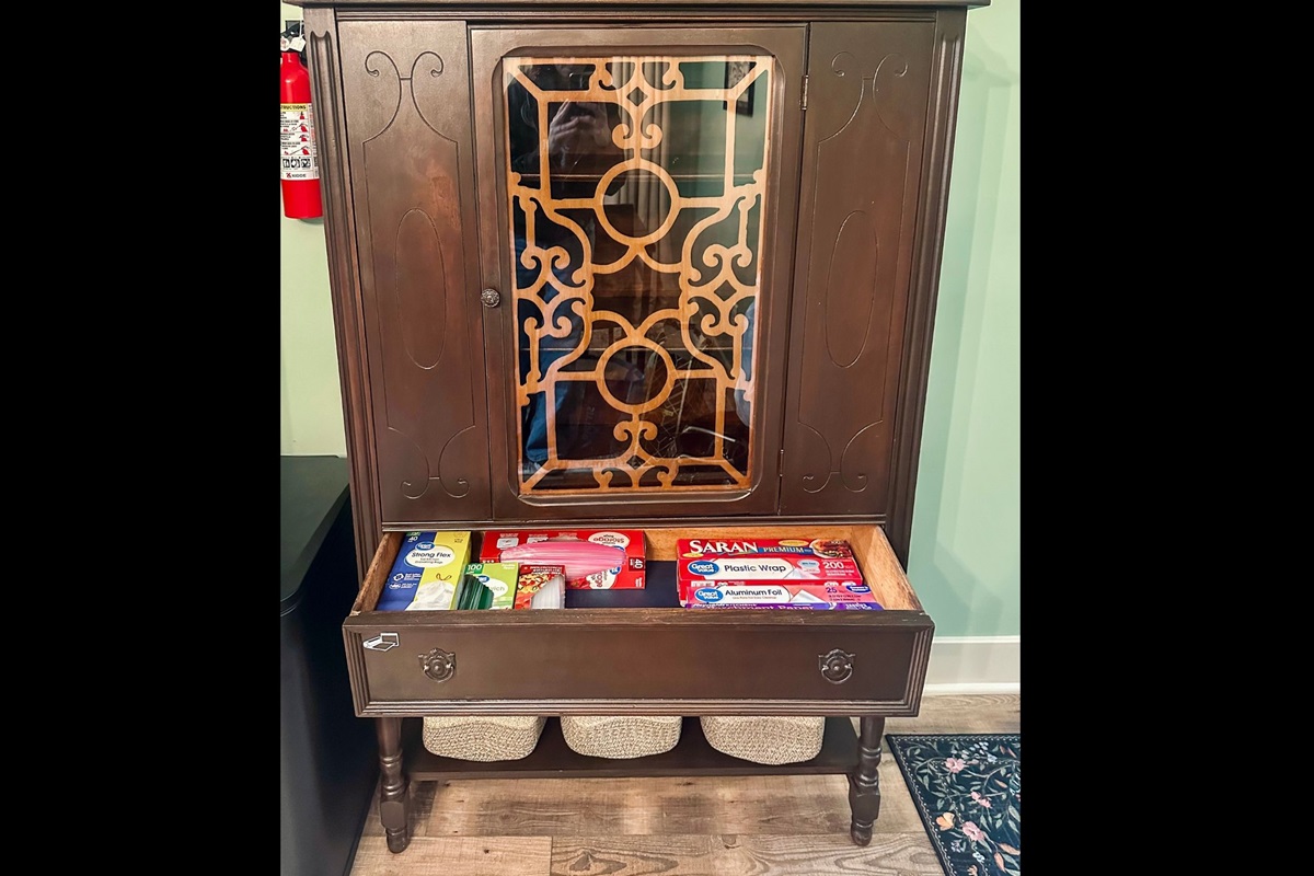 Pantry drawer organized with trash bags, plastic wrap, wax paper, foil, and food storage bags to make extended stays simple and convenient.