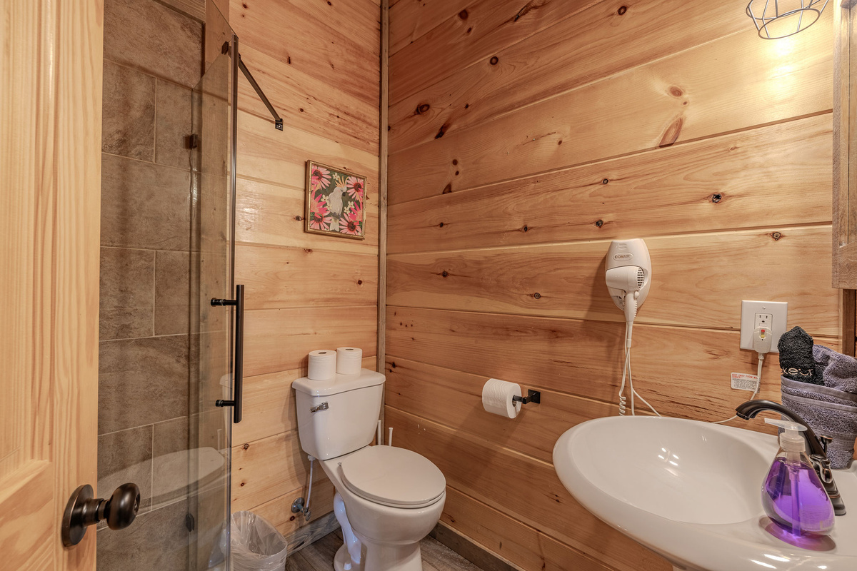 The Junior Explorers shared bathroom supports the lower-level bunk room, theater, and pool areas.