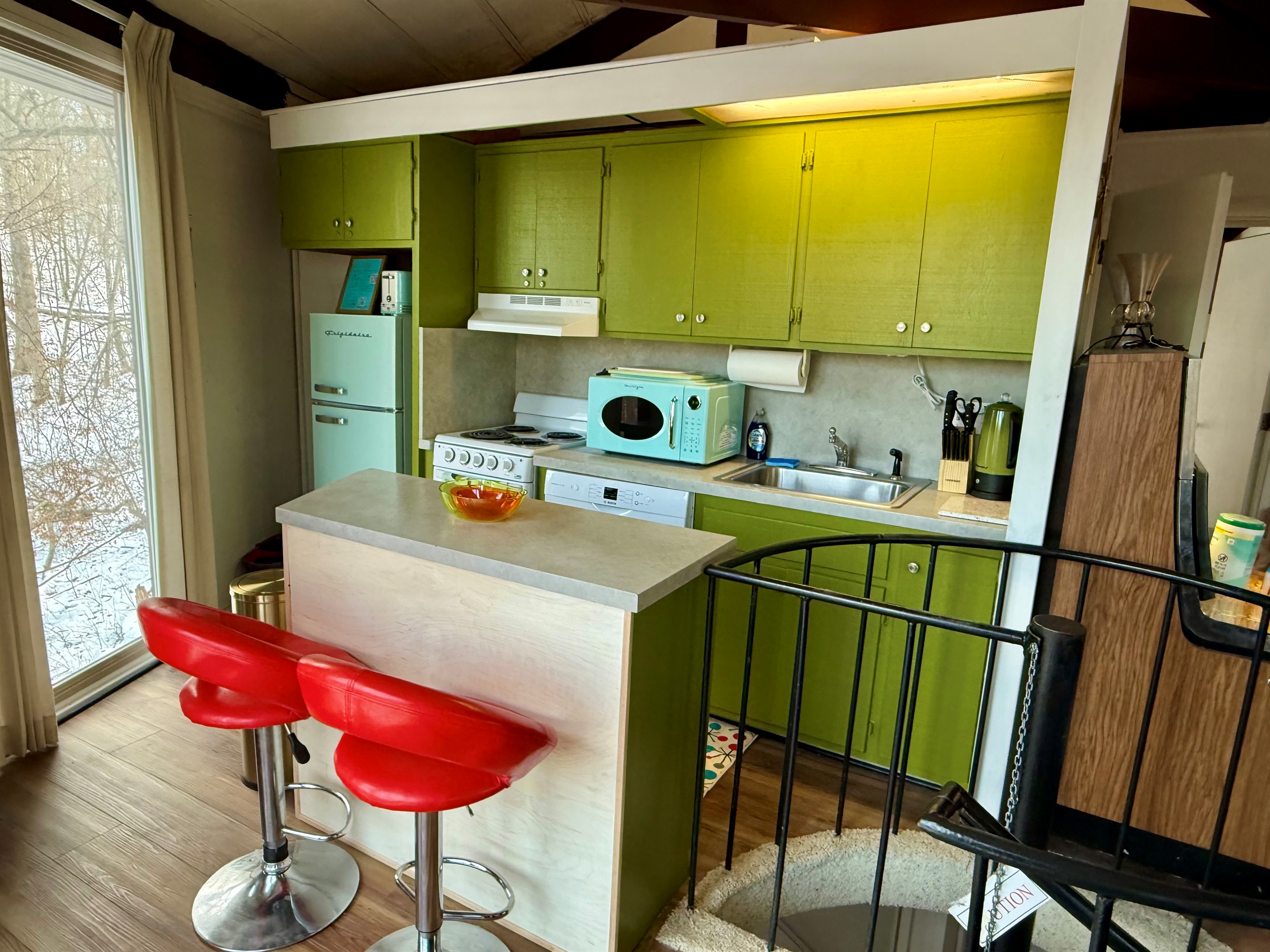 Kitchen with dishwasher, stove, microwave, fridge