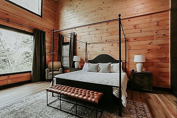 A peaceful bedroom retreat with natural light and calming forest views to start and end your day