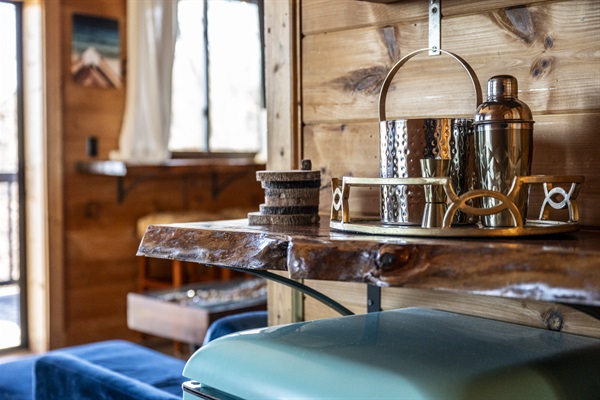 A little mini bar shelf nook that can be used to set up your own bar above the mini fridge with provided bar accessories.