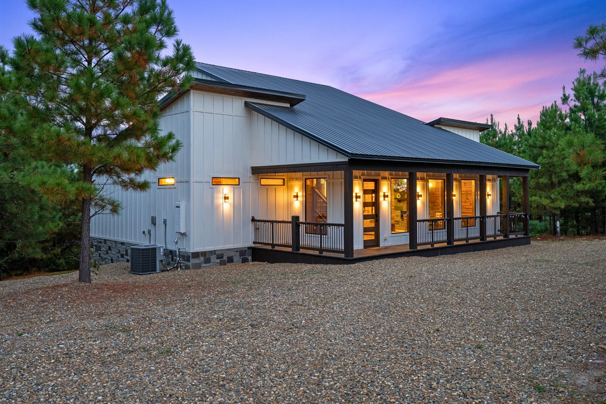 Side view of the cabin showing modern design and outdoor living spaces.
