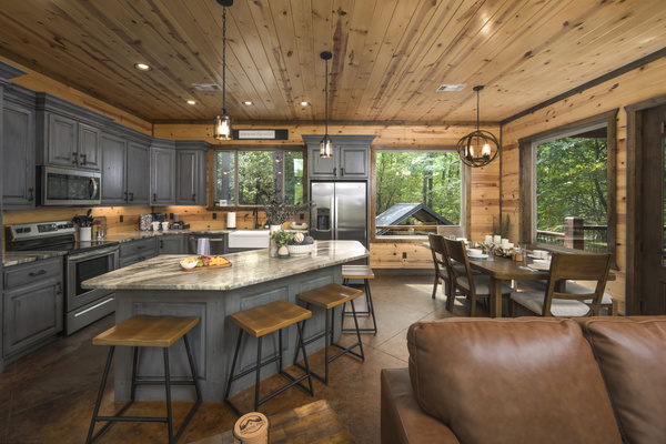Step into culinary bliss in this stylish kitchen. Those gray cabinets and sleek stools make it the perfect spot for family gatherings.