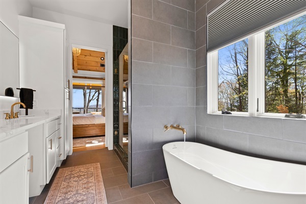 Unwind in style with this inviting space: from a warm soak to the serene woodland view, relaxation awaits in every corner.