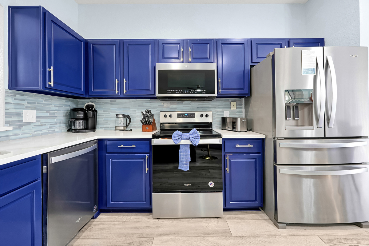 Kitchen appliances and blue cabinets