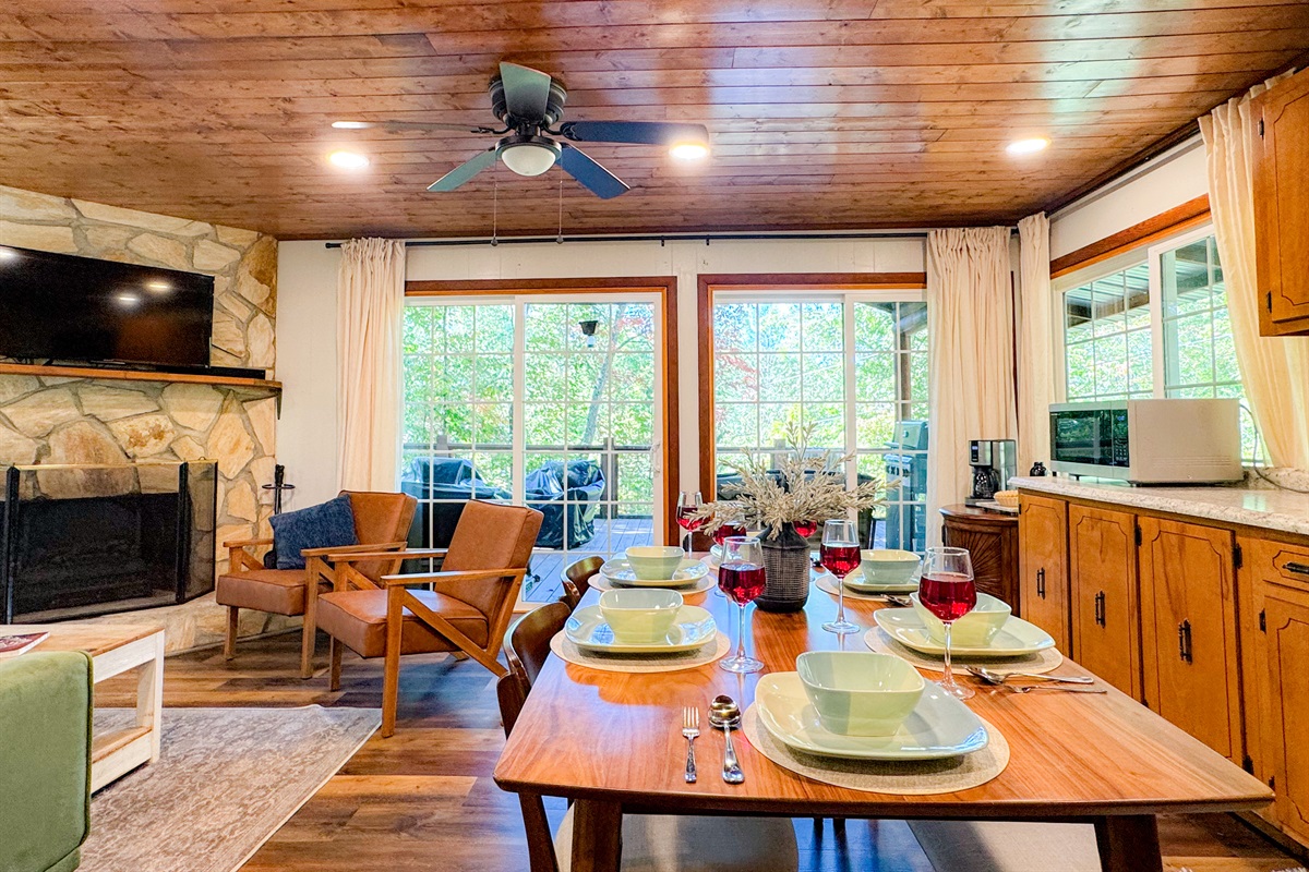 Our dining area features seating for 6. The open concept kitchen, dining, and living room area all overlook the woodlands providing a tree house feel from inside!