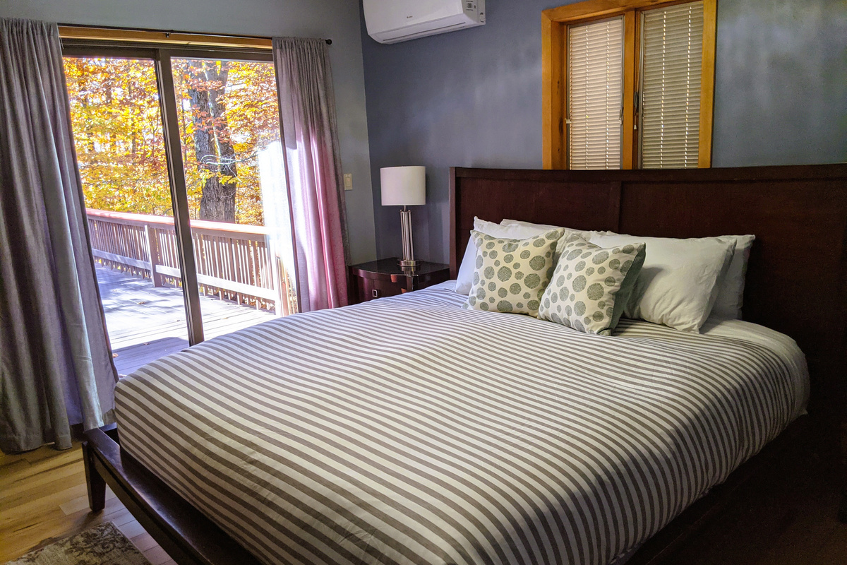 Master bedroom with King-sized Bed, TV, Ceiling Fan, Split unit AC and private deck access