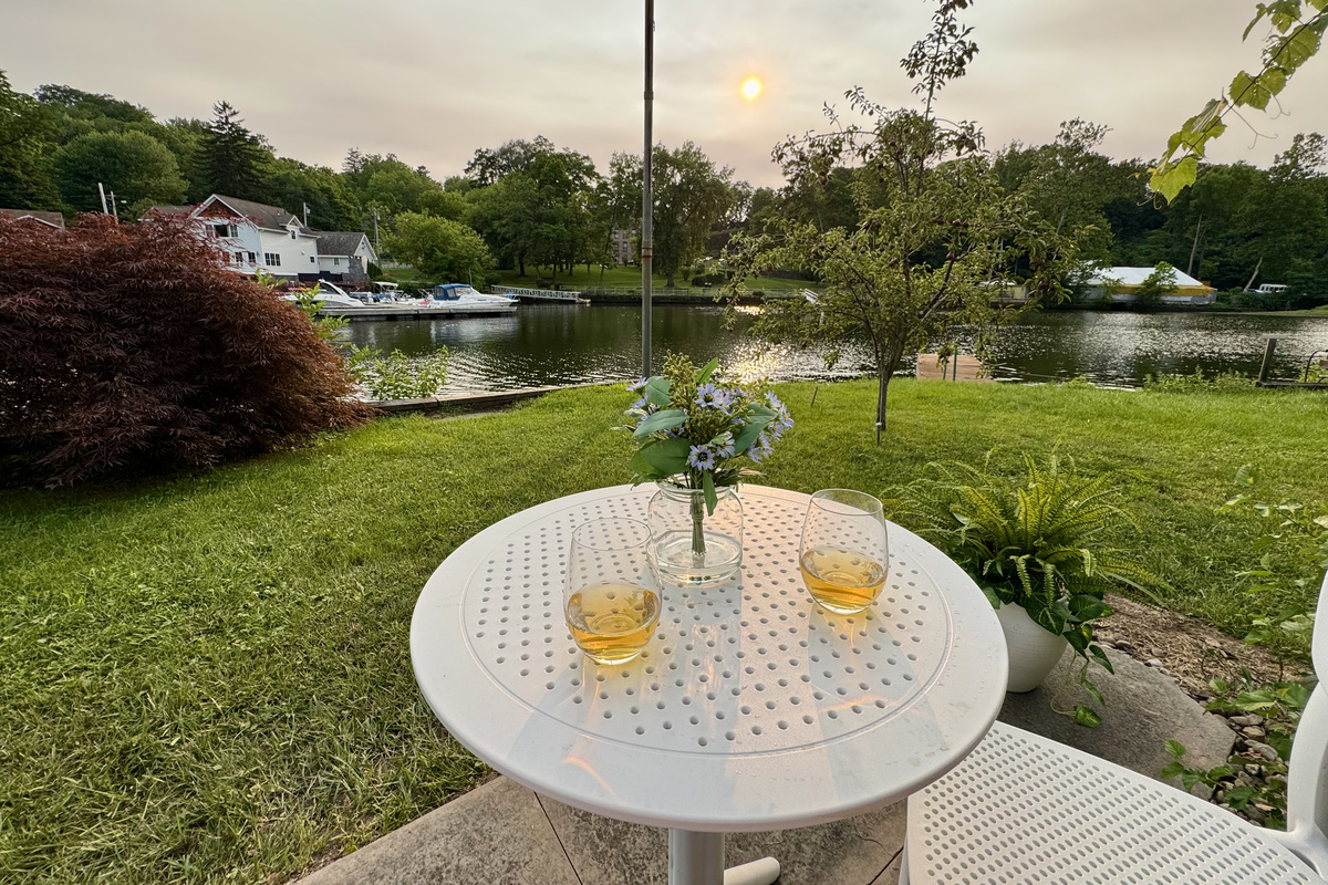 End the day with a glass of wine and one of the best seats on the river.