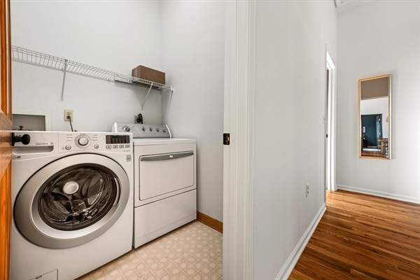 Laundry room with washer and dryer, stocked with pods, stain remover, and wool dryer balls—everything you need for longer stays or post-adventure cleanups.