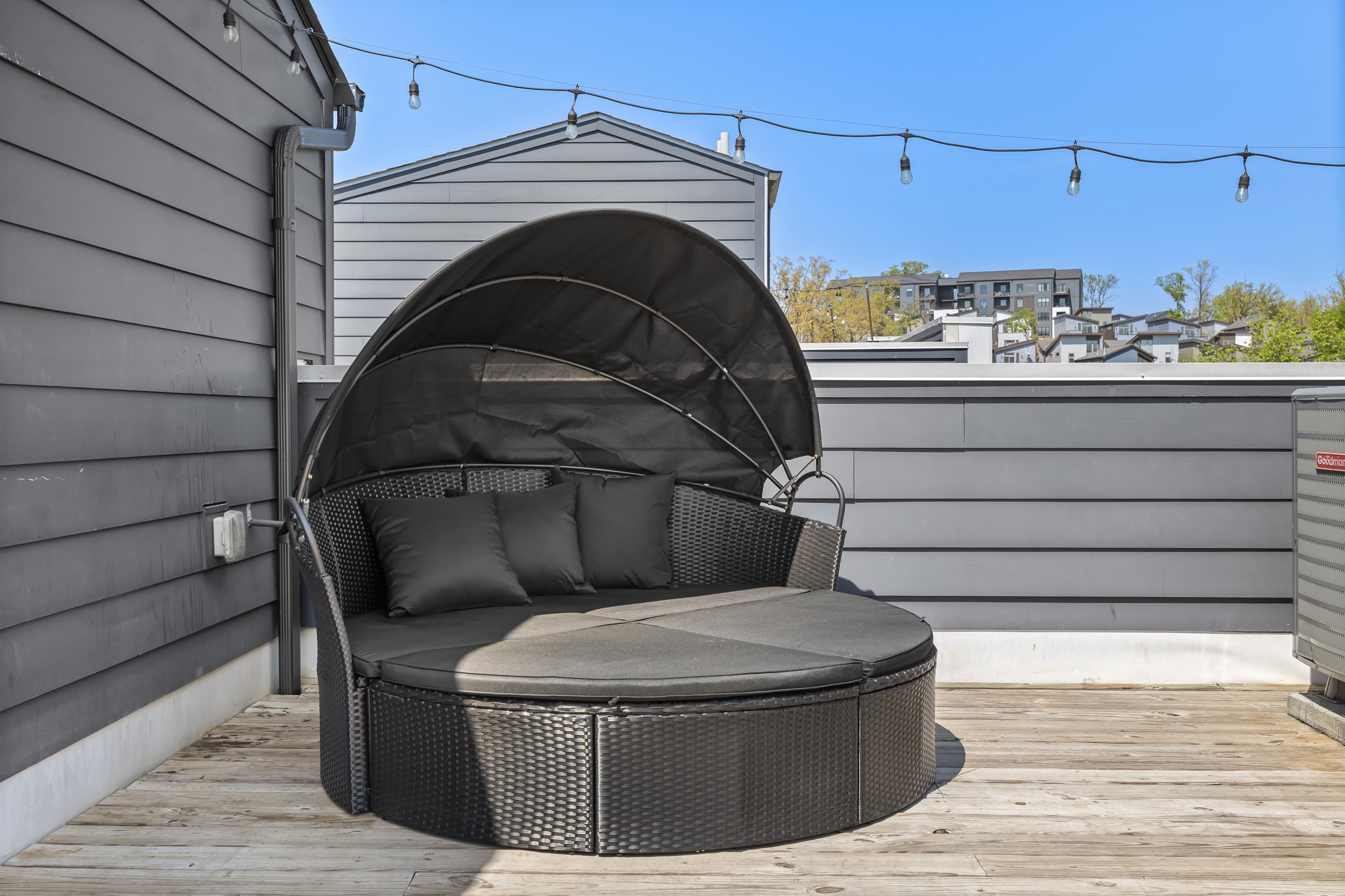 Rooftop Retreat: Lounge in style on this chic round daybed with stunning urban views!