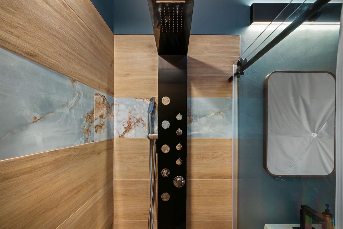 Indulge in a spa-like shower surrounded by natural light and earthy touches for the ultimate retreat.