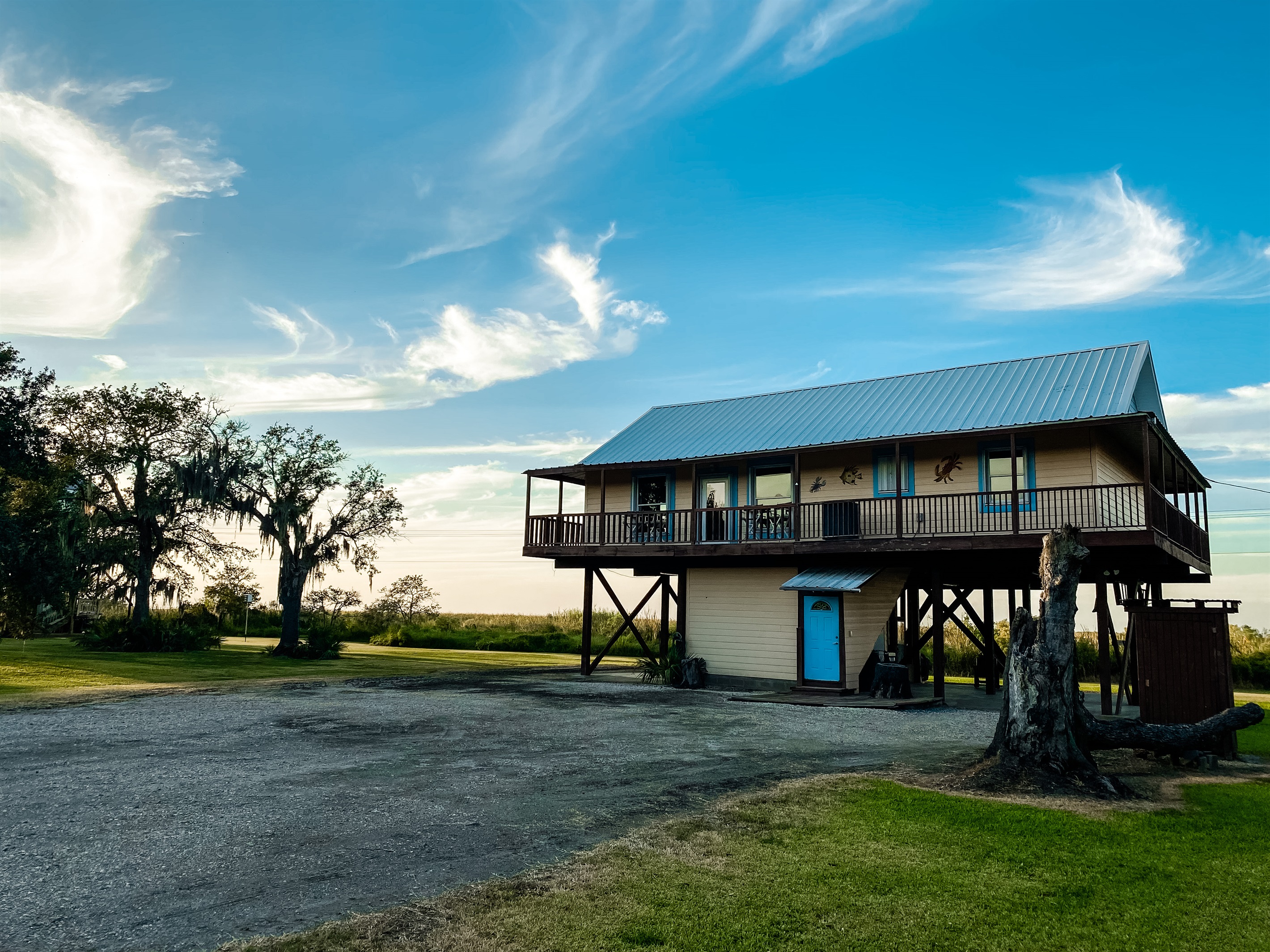 Entrance includes interior stairs.  Covered wrap around porch upstairs to enjoy views from all sides.