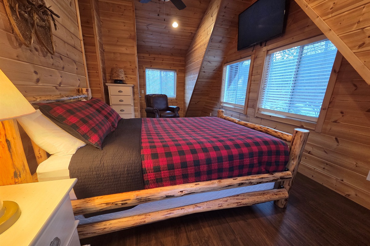 Upstairs, the second bedroom offers a cozy queen-size bed for a restful night’s sleep.