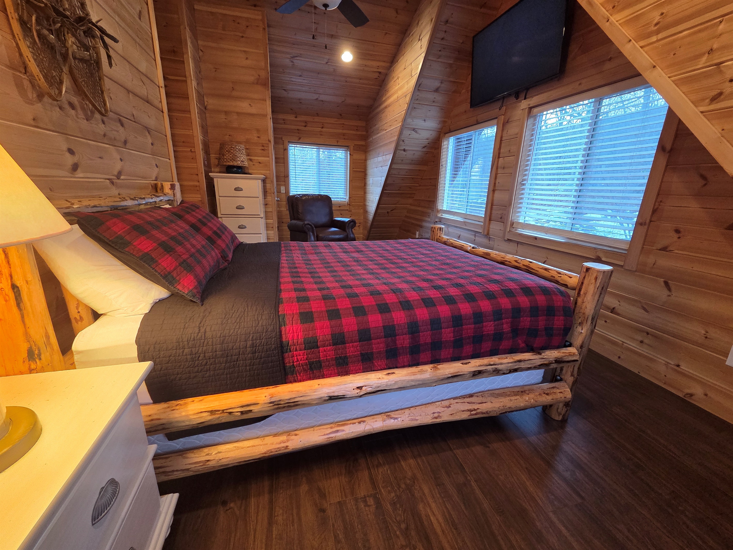 Upstairs, the second bedroom offers a cozy queen-size bed for a restful night’s sleep.