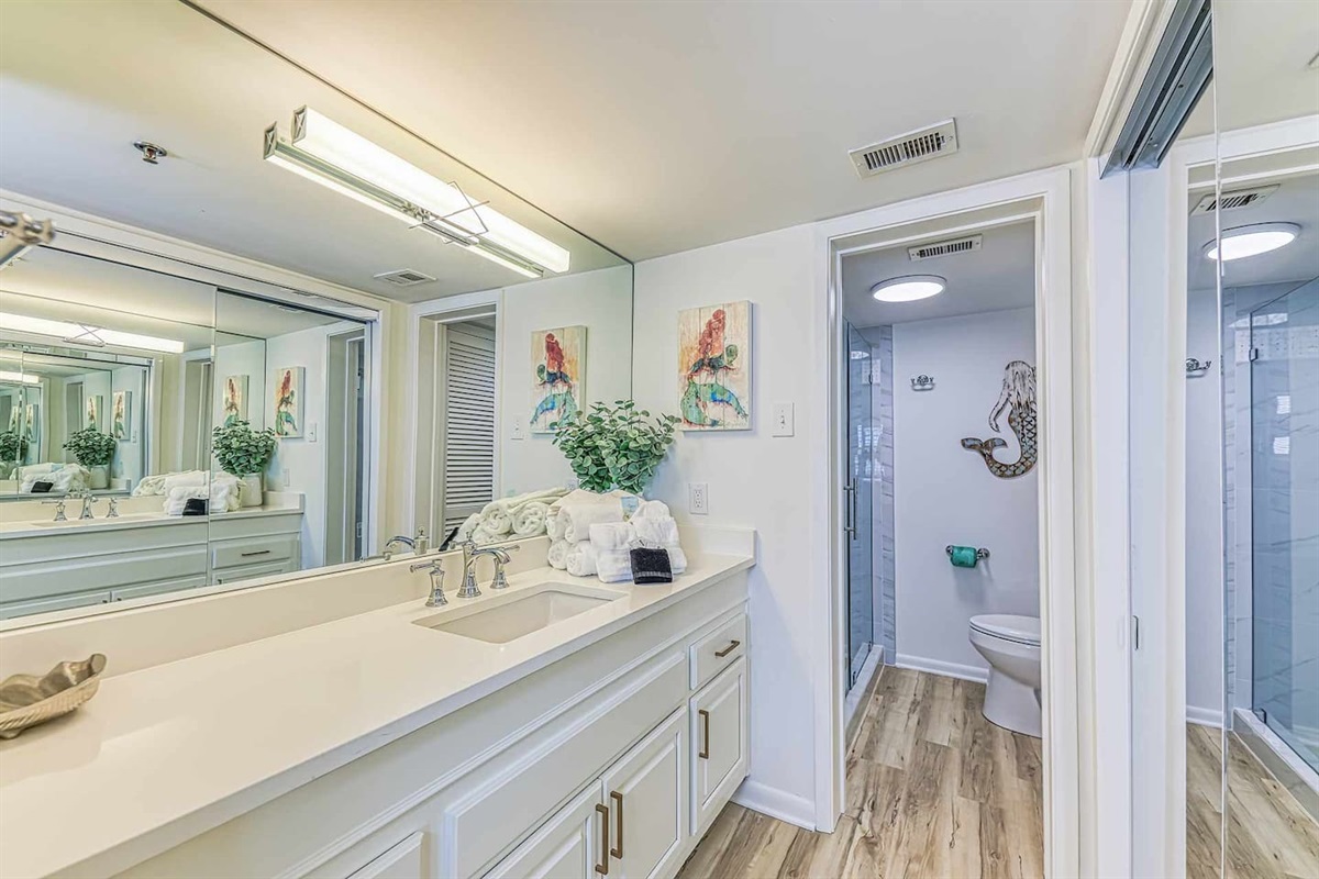 Bathroom Oasis: Bright and airy retreat with modern fixtures and stylish ocean-inspired decor!