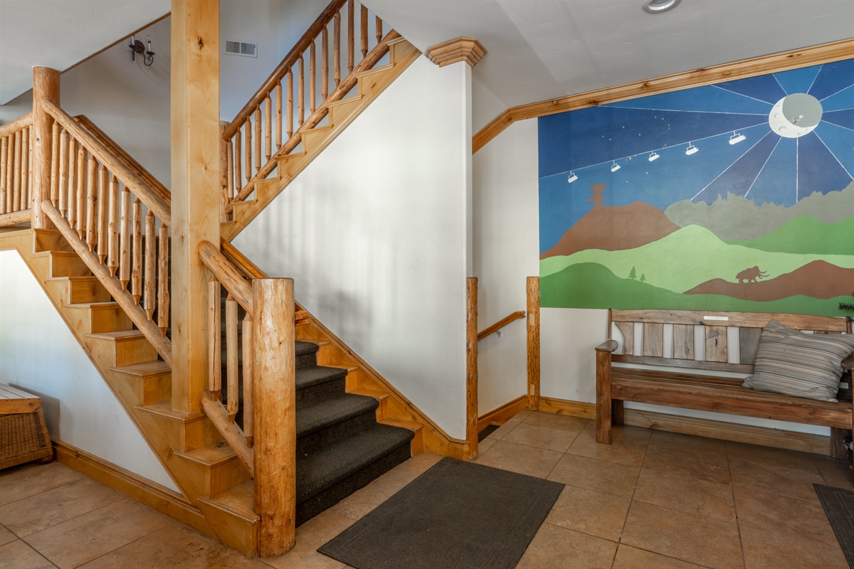 Inviting foyer with custom Mammoth Mountain mural and access to condos and garage.