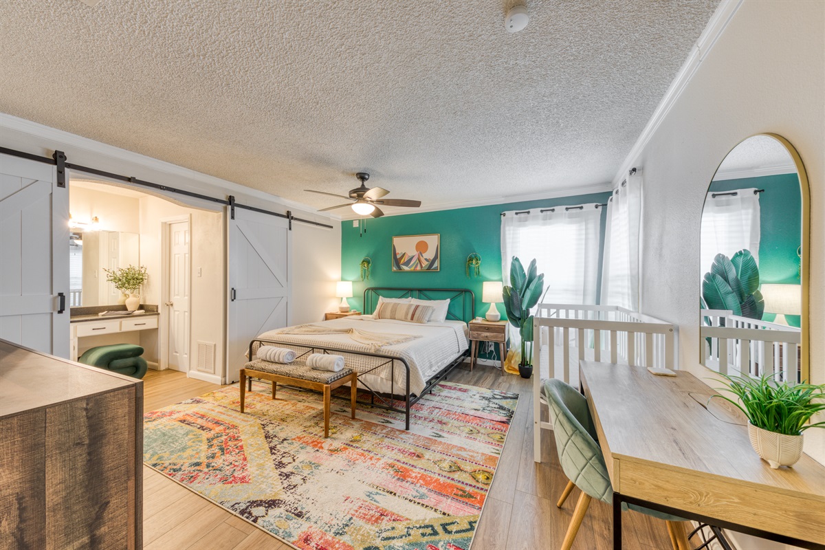 Master bedroom with king bed, crib
