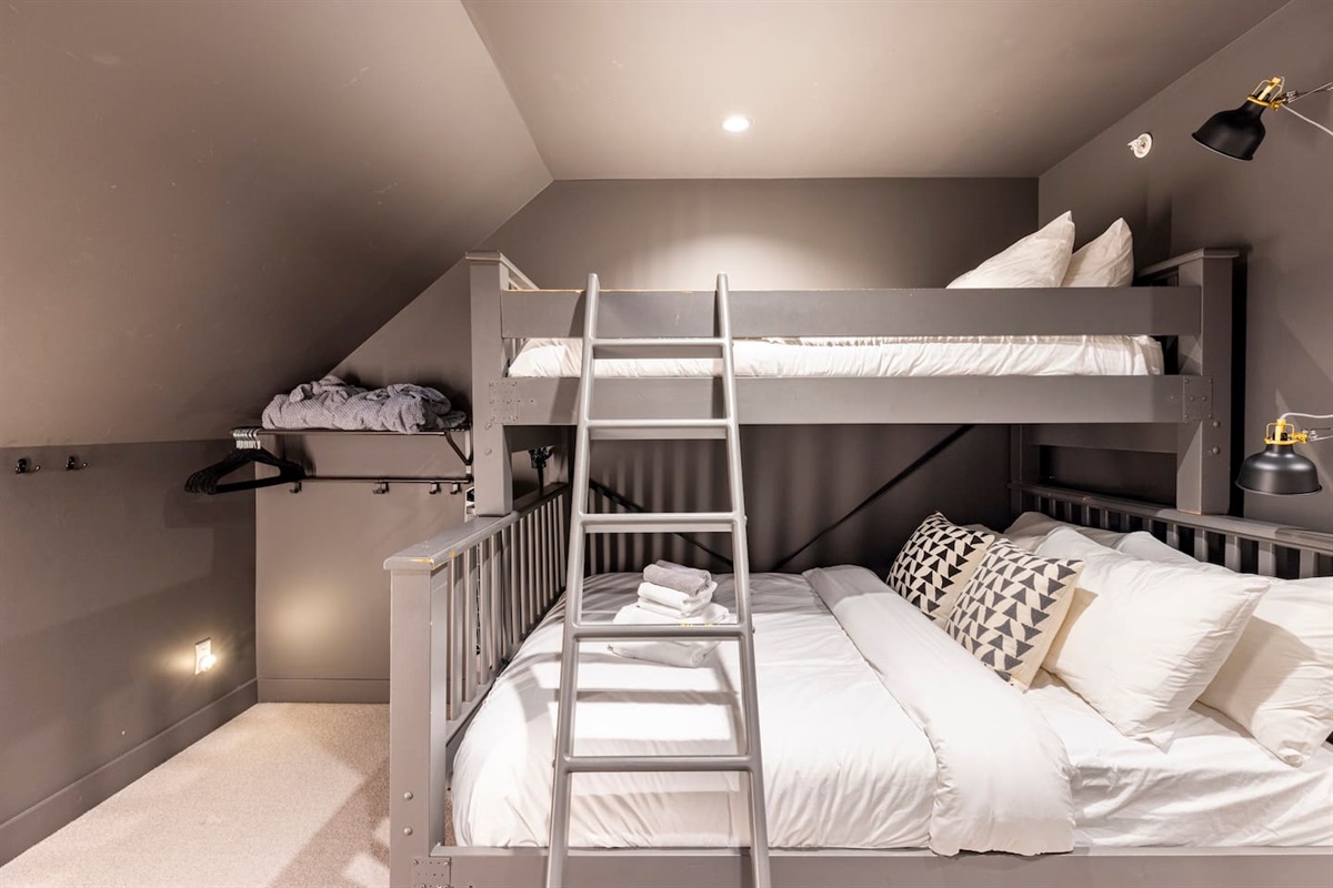 Single over queen bunk beds in the media room upstairs. There is a large bathroom off the media room. The shower will be shared with those using the queen bedroom on this level.
