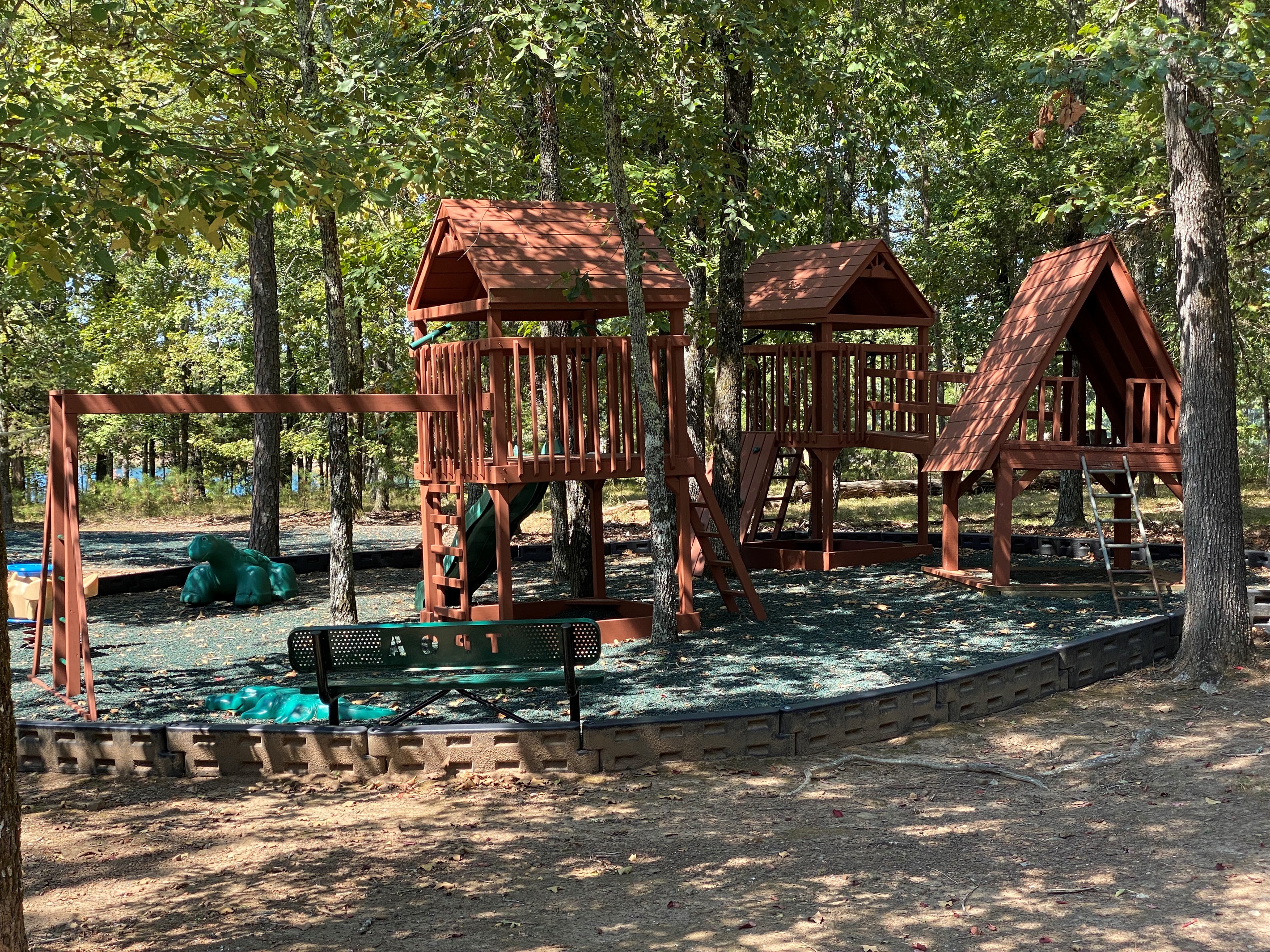 A play area nestled in the trees invites imagination and adventure for younger guests.