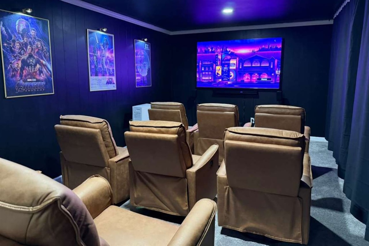 Private home theater with plush recliners, surround sound, and a 4K screen while you enjoy microwave pop corn and access to minifridge and bar table — the ultimate movie-night experience