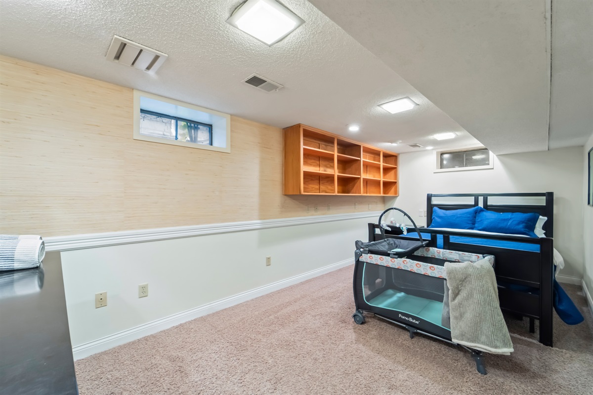 This bedroom is at the foot of the stairs in the basement. During the summer this room stays cooler than other rooms and is pretty dark. There are tons of plug-ins to charge all your devices.