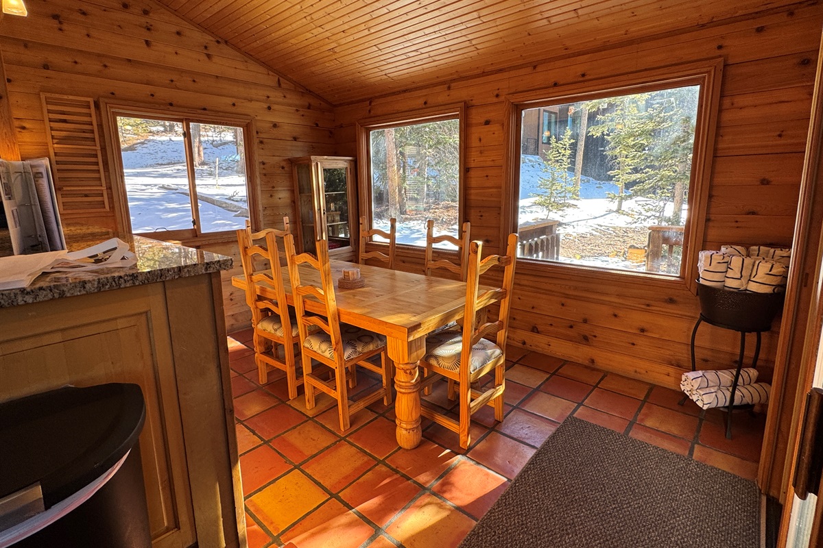Informal dining area with big picture windows and a lot of natural light