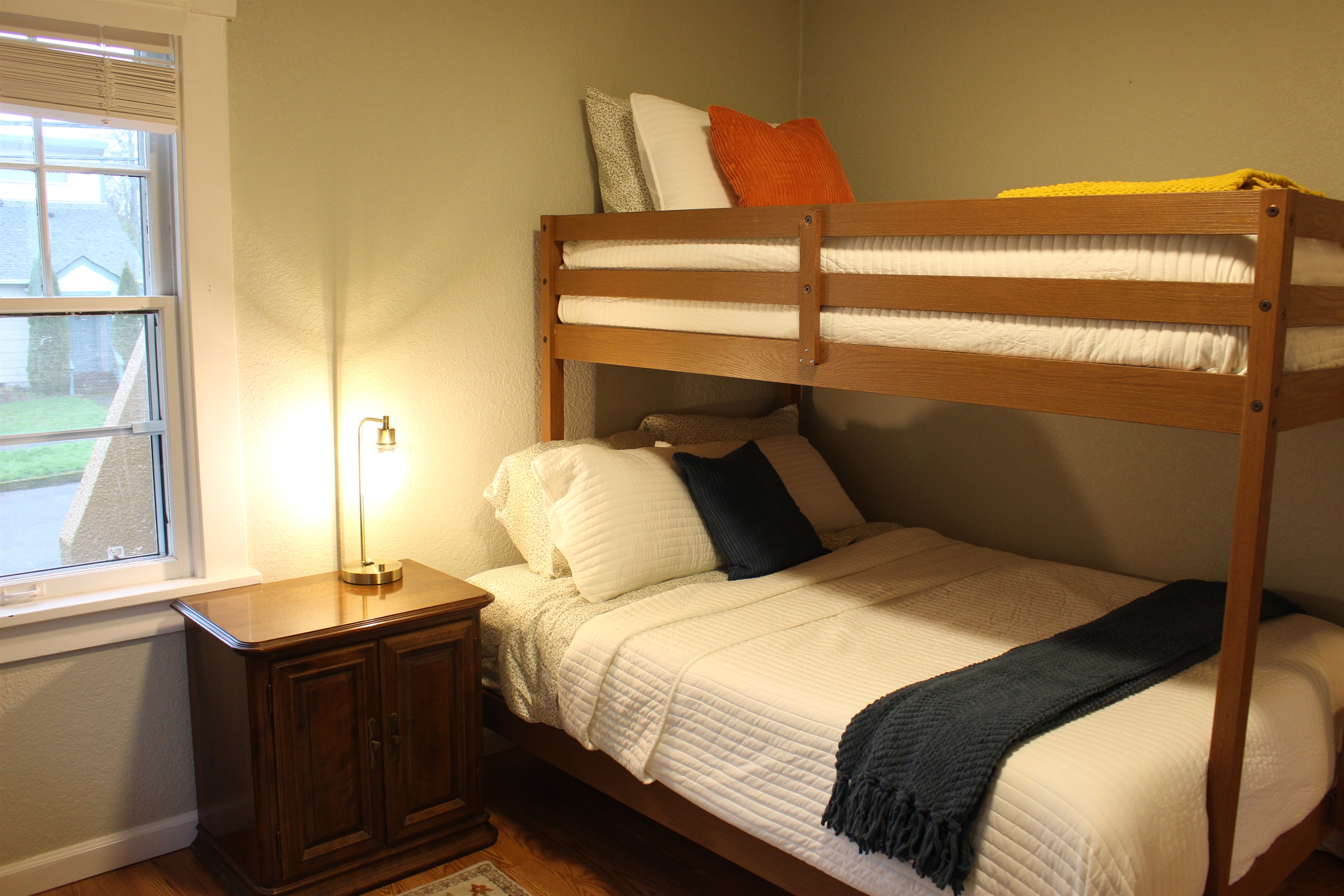 Twin over full bunk beds main floor with highchair, baby gate and pack and play in this closet